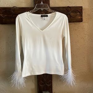 Cream colored top with feather trim